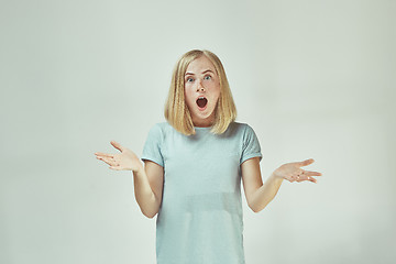 Image showing Beautiful woman looking suprised isolated on gray