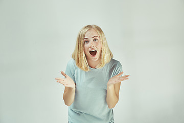 Image showing Beautiful woman looking suprised isolated on gray