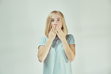 Image showing Beautiful woman looking suprised isolated on gray