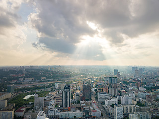 Image showing Panoramic view to a central part of Kiev, Ukraine with modern buildings on a cloudy sunset background in the summer. Aerial view from drone.