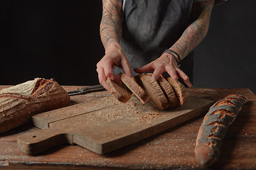 Image showing Baker Holds Bran Bread