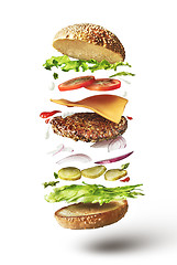 Image showing Delicious hamburger with flying ingredients