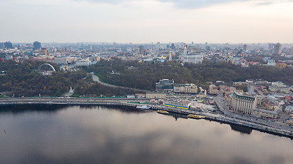 Image showing The panoramic bird\'s eye view shooting from drone of the Podol district, the right bank of the Dnieper River and centre of Kiev, Ukraine at summer sunset on the background of the cloudy sky.