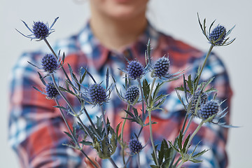 Image showing Young girl holding a blue flower