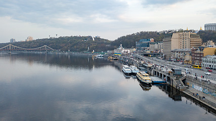 Image showing View of the pedestrian bridge, the Vladimirskaya Hill with the monument of the Arco-Soviet of the People, the river Dnipro and tourist parades in Kyiv