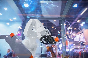 Image showing Automatic robot arm working in industrial environment