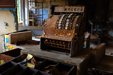 Image showing Old and rusty cash mashine on the desk