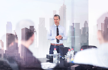 Image showing Confident company leader on business meeting against new york city manhattan buildings and skyscrapers window reflection.