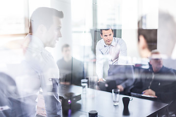 Image showing Business team brainstorming on meeting in modern corporate office.