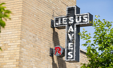 Image showing Neon Jesus Saves Sign Brick Wall Church Exterior