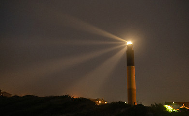 Image showing Oak Island Lighthouse Beams into the Seafoam at Fort Caswell