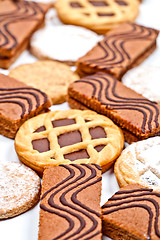 Image showing Cake bars filled with cream, oat cookies and tarts with dark cho