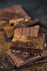 Image showing Chocolate bar pieces heap witn cinnamon powder.