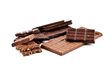 Image showing Heap of broken dark and milk chocolate bars with hazelnuts.