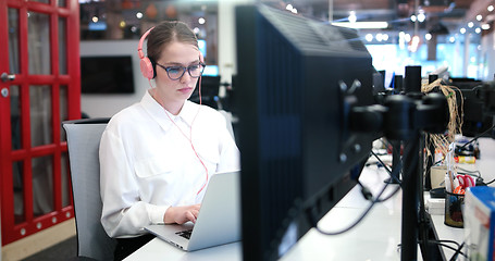 Image showing businesswoman using a laptop in startup office