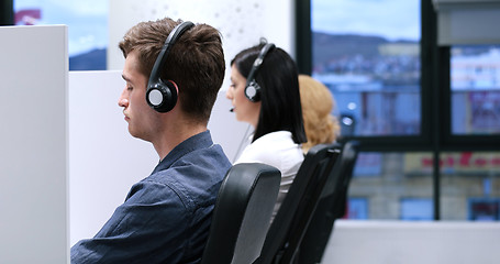 Image showing male call centre operator doing his job