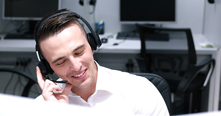 Image showing male call centre operator doing his job