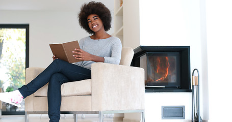 Image showing black woman at home reading book