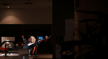 Image showing man working on computer in dark office