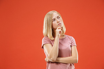 Image showing Young serious thoughtful blonde with freckles woman. Doubt concept.