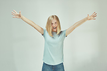 Image showing Winning success woman happy ecstatic celebrating being a winner. Dynamic energetic image of female model