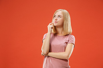 Image showing Young serious thoughtful blonde with freckles woman. Doubt concept.
