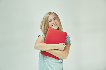 Image showing Businesswoman hugging laptop. Love to computer concept. Attractive female half-length front portrait