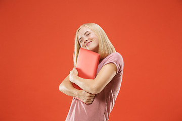 Image showing Businesswoman hugging laptop. Love to computer concept. Attractive female half-length front portrait