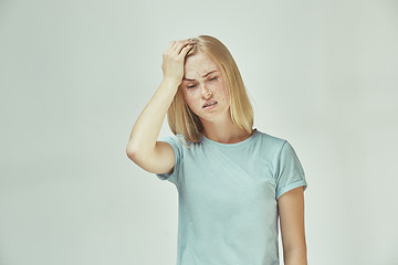 Image showing Woman having headache. Isolated over pastel background.