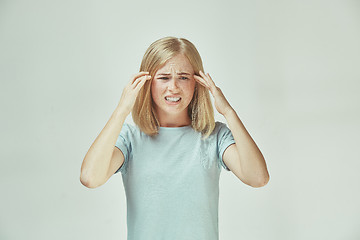 Image showing Woman having headache. Isolated over pastel background.