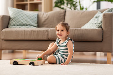 Image showing happy baby girl playing with toy blocks at home