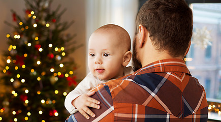 Image showing close up of father holding baby son on christmas