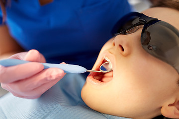 Image showing boy having teeth checkup at dental clinic