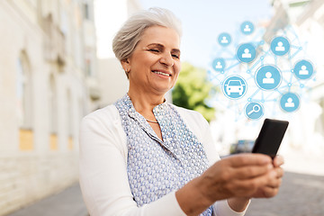 Image showing senior woman with smartphone and car sharing icons