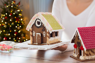 Image showing close up of woman with christmas gingerbread house