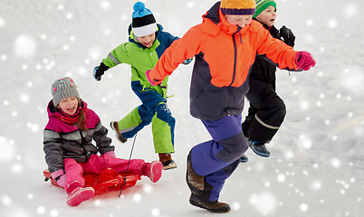 Image showing happy kids with sled having fun outdoors in winter