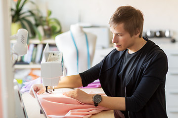 Image showing fashion designer with sewing machine working