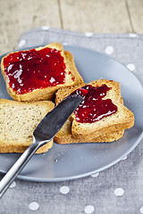 Image showing Fresh toasted cereal bread slices with homemade cherry jam and k