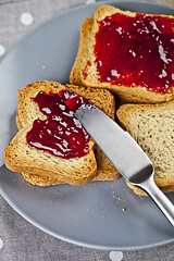 Image showing Fresh toasted cereal bread slices with homemade cherry jam and k