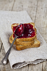 Image showing Toasted cereal bread slices stack with homemade cherry jam and s