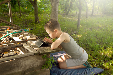 Image showing Boy playing on tablet