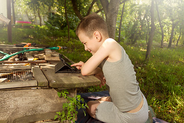 Image showing Boy playing on tablet