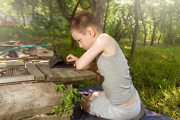 Image showing Boy playing on tablet