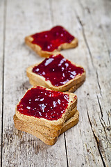 Image showing Toasted cereal bread slices with homemade cherry jam closeup on 