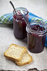 Image showing Toasted cereal bread slices on blue ceramic plate and homemade c