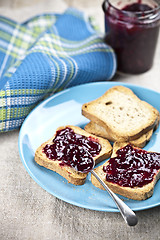 Image showing Toasted cereal bread slices on blue ceramic plate and homemade w