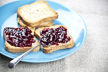 Image showing Fresh toasted cereal bread slices with homemade wild berries jam