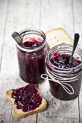 Image showing Cereal bread toasts slices and jars with homemade wild berries a