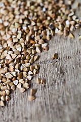 Image showing Fresh green dry buckwheat seads closeup on rustic wooden backgro