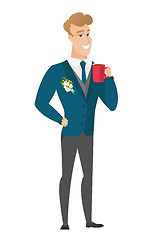 Image showing Young caucasian groom holding cup of coffee.